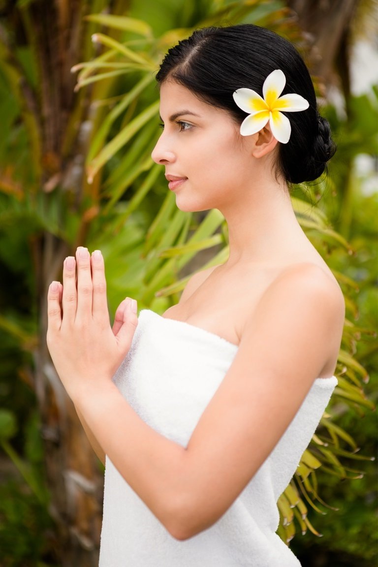 Pretty woman praying before her spa day in an health farm